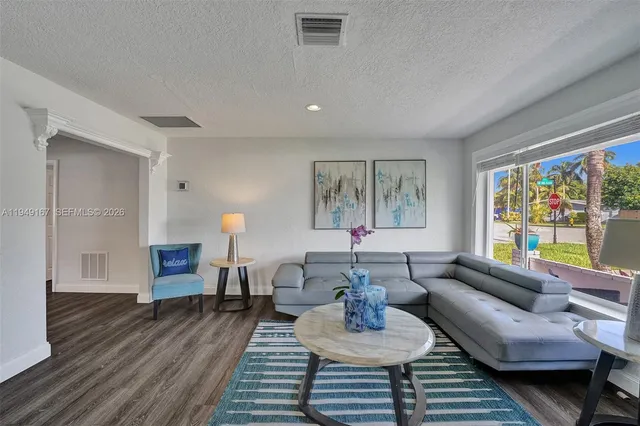 a living room with furniture or couch and a wooden floor