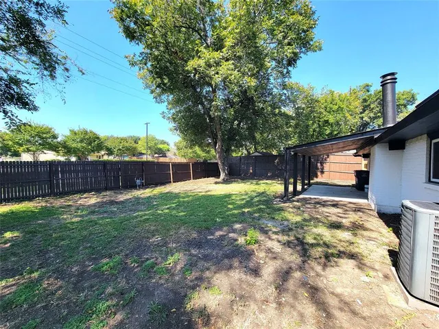 a backyard of a house with lots of green space