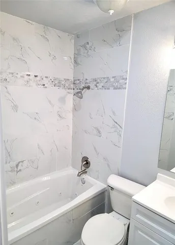 a bathroom with a toilet and a bathtub