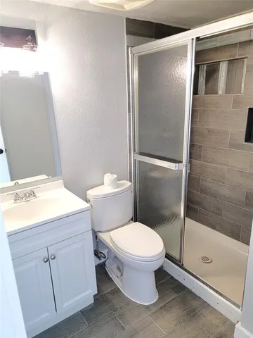 a bathroom with a sink toilet and shower