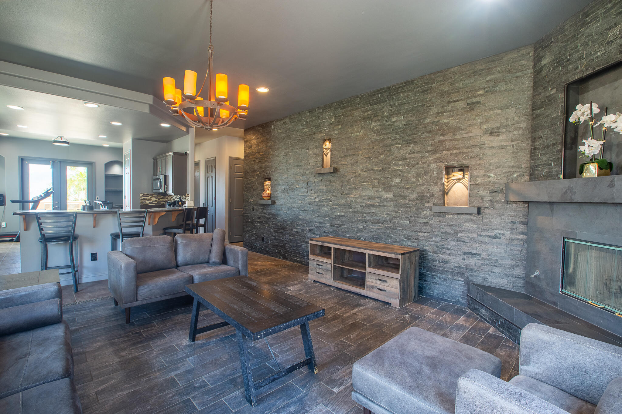 66862 San Rafael Road Desert Hot Springs, CA 92240 - Photo 5 of 33 a living room with furniture a chandelier and a fireplace