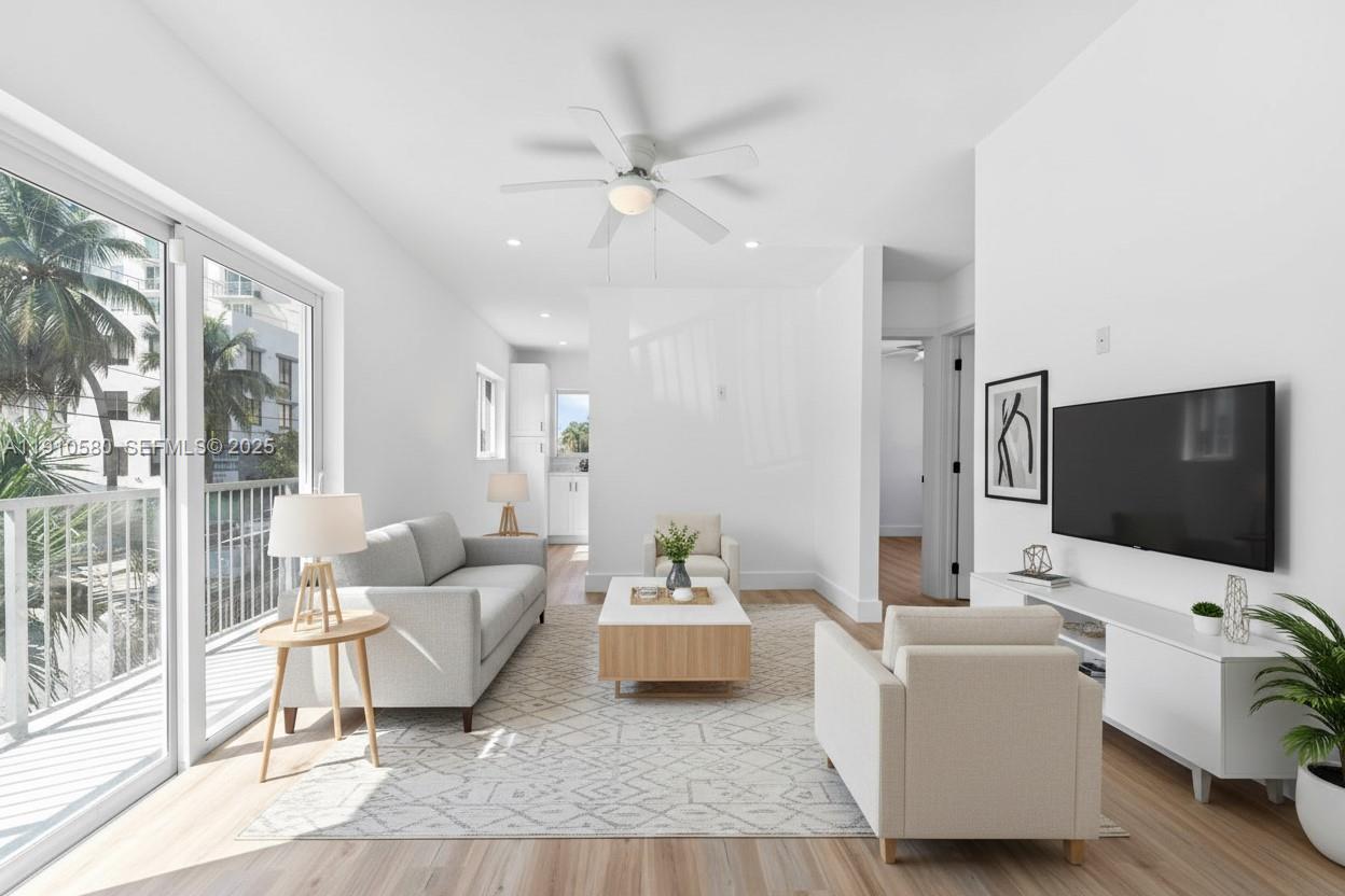 300 Northwest 7th Avenue, Unit 1 Miami, FL 33128 - Photo 1 of 10 a living room with furniture and a flat screen tv