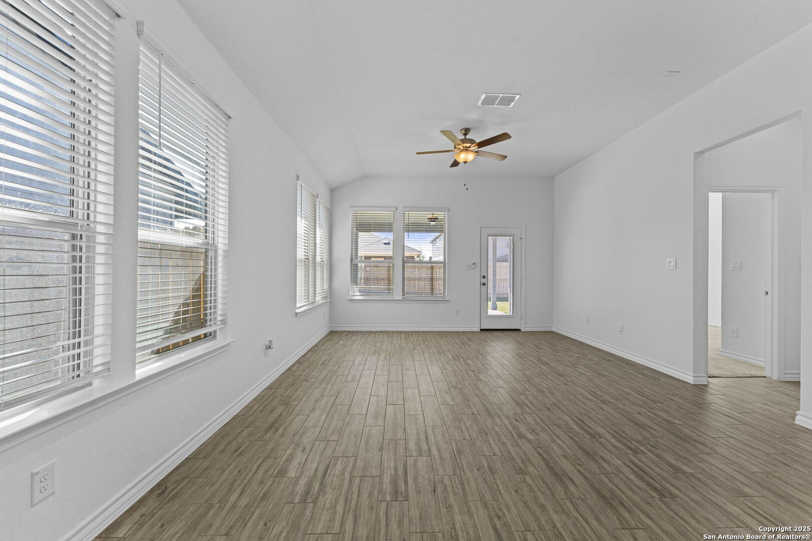 4040 Paddock Trail Seguin, TX 78155 - Photo 15 of 26 a view of an empty room with a window and wooden floor