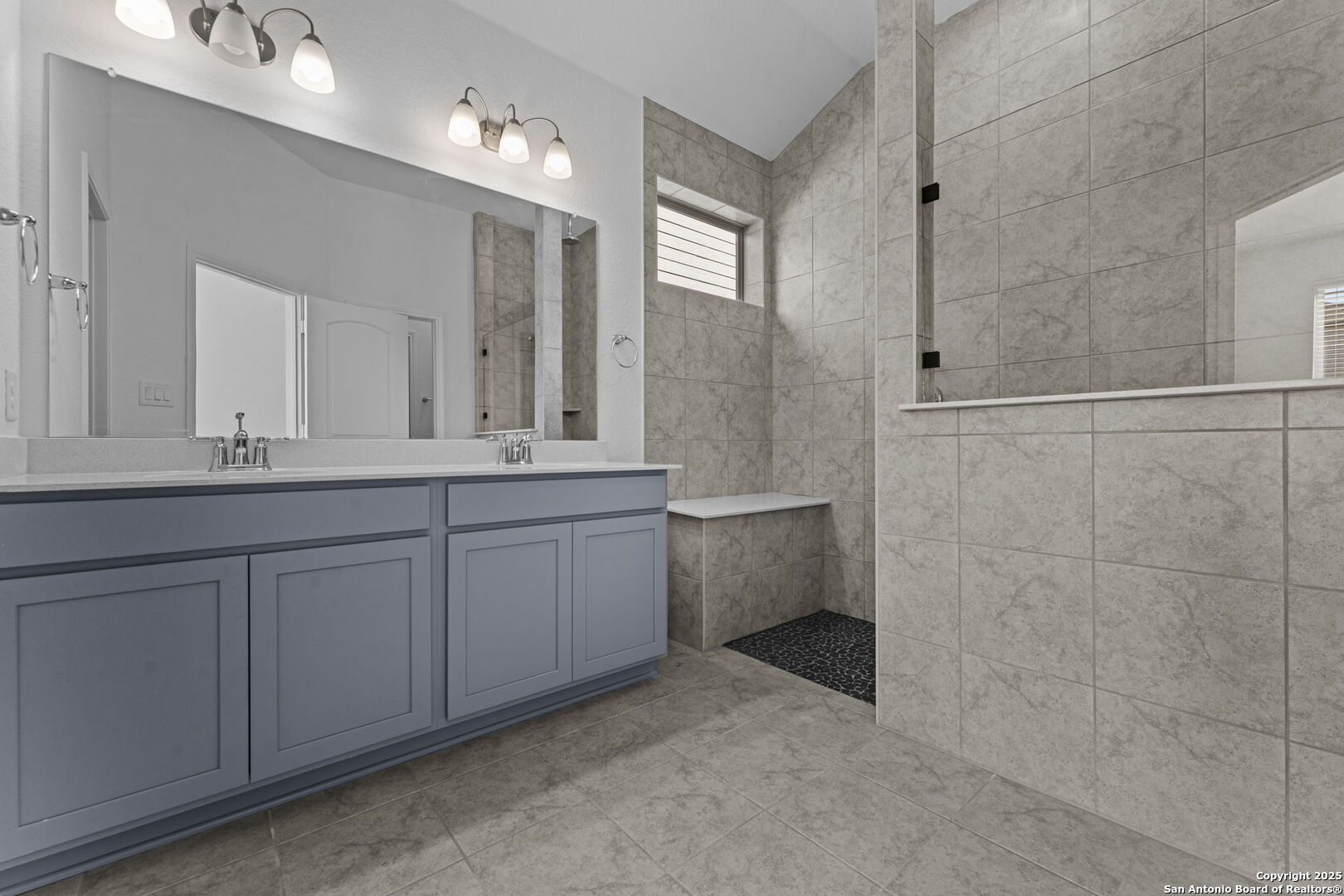 4040 Paddock Trail Seguin, TX 78155 - Photo 21 of 26 a bathroom with a double vanity sink a toilet and a mirror