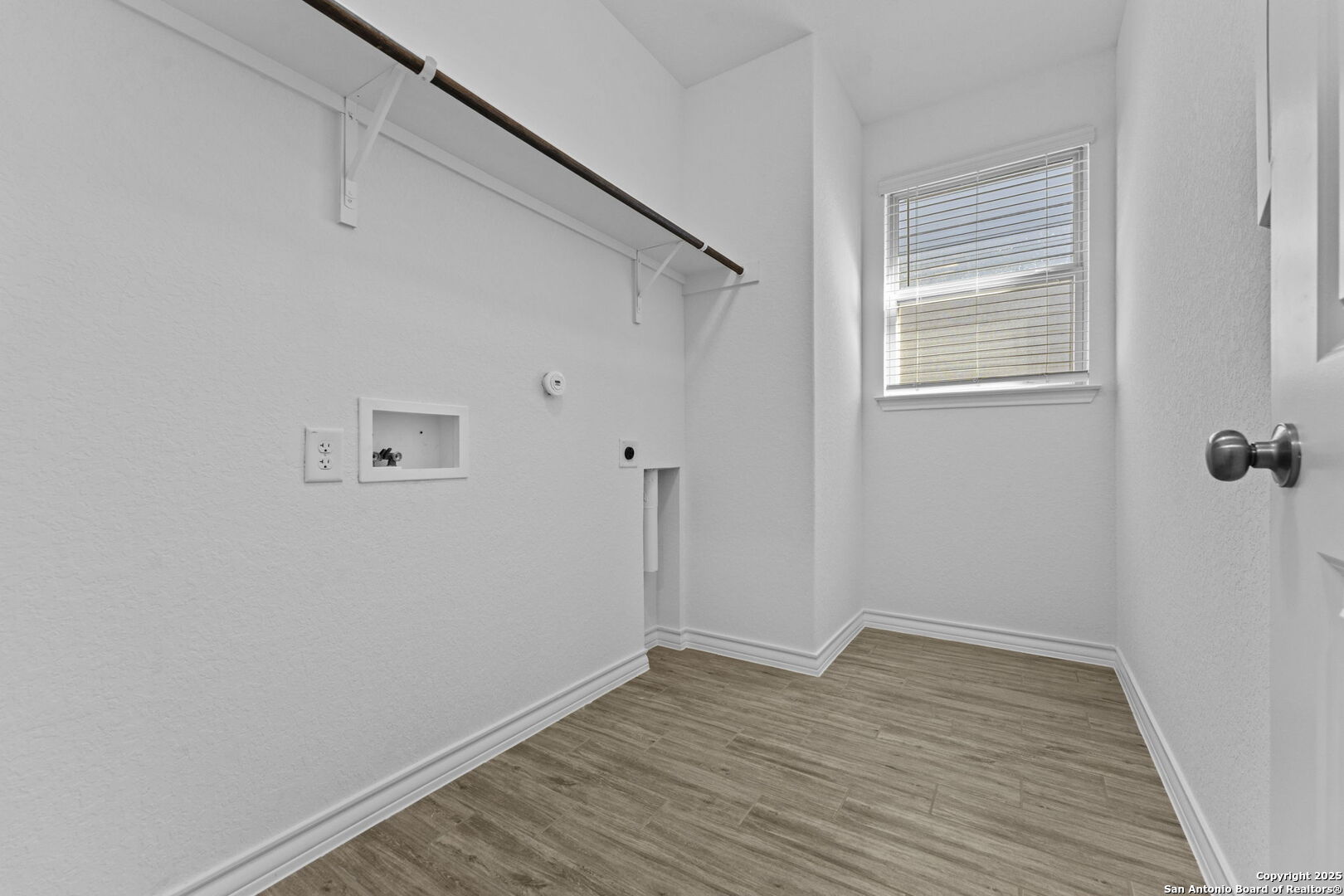 4040 Paddock Trail Seguin, TX 78155 - Photo 10 of 26 a view of a room with wooden floor and a window