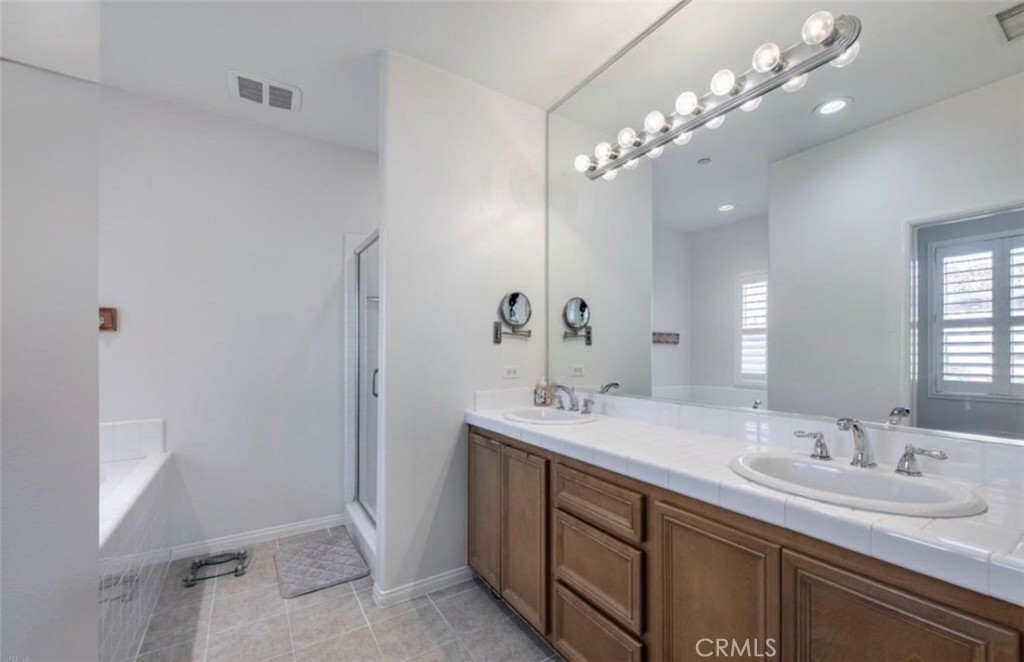 2931 Esperanza Way, Unit B Simi Valley, CA 93063 - Photo 25 of 49 a bathroom with a double vanity sink and a mirror