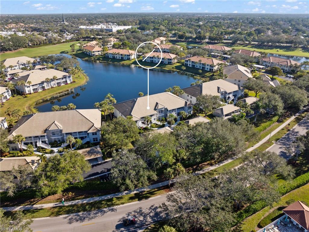 2265 Harmony Lane, Unit 102 Naples, FL 34109 - Photo 2 of 4 an aerial view of lake residential house with outdoor space