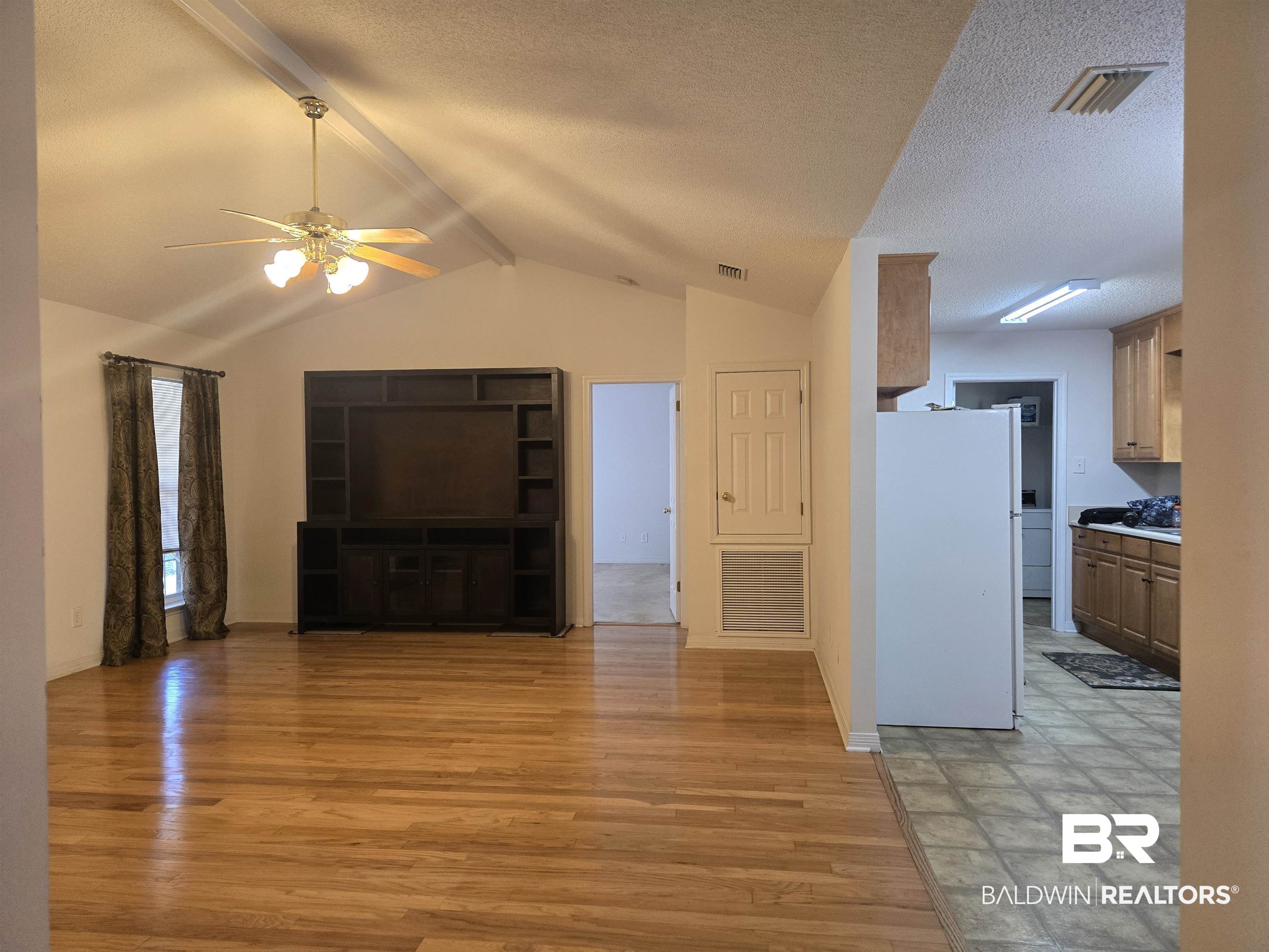 2554 Riverside Drive Mobile, AL 36605 - Photo 19 of 43 Unfurnished living room featuring a ceiling fan, light wood finished floors, and a textured ceiling