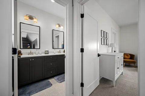 a spacious bathroom with a double vanity sink and a mirror