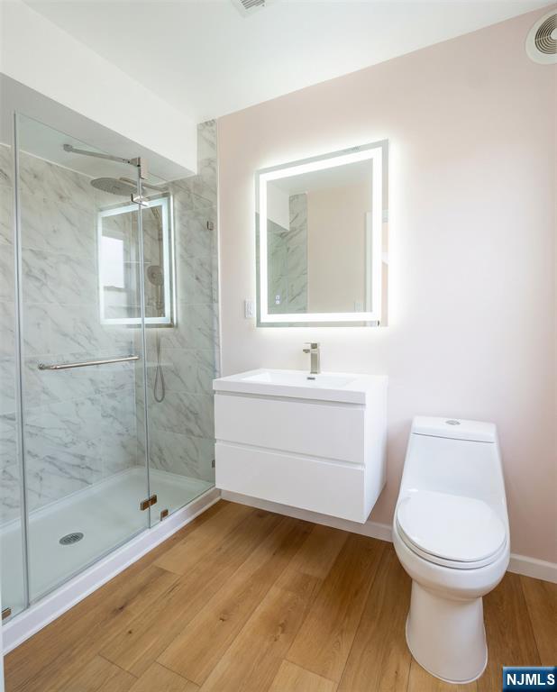 346 Alan Drive Paramus, NJ 07652 - Photo 11 of 21 a bathroom with a sink a toilet and shower