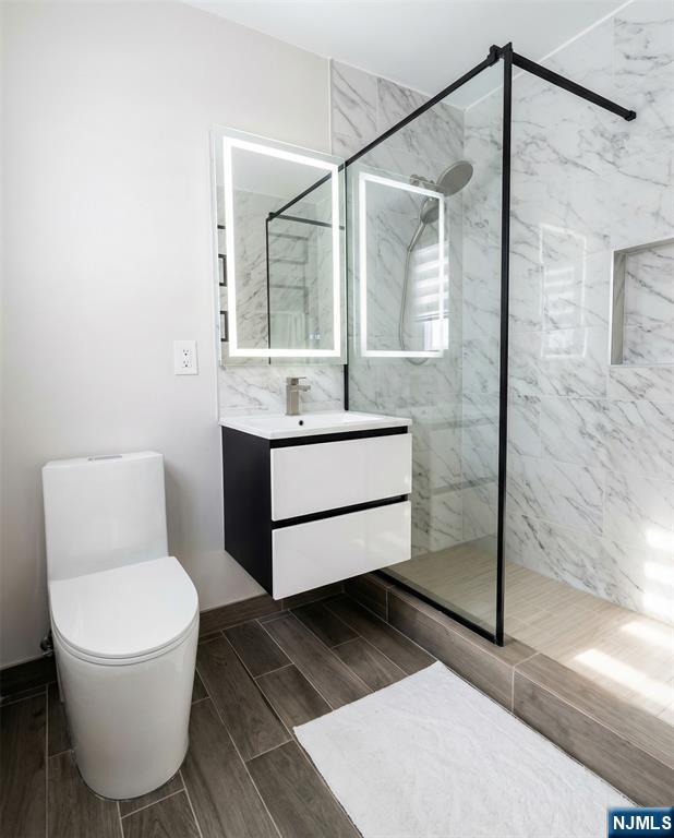 346 Alan Drive Paramus, NJ 07652 - Photo 16 of 21 a bathroom with a sink toilet and shower