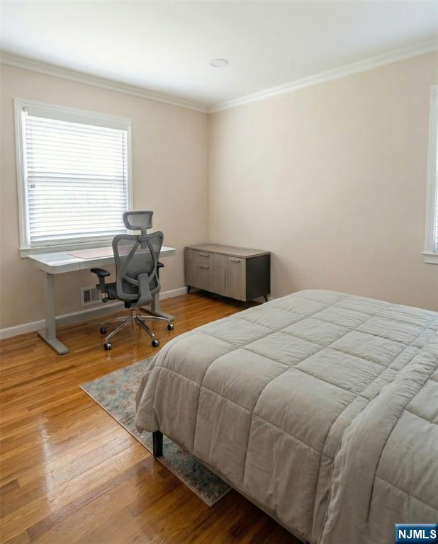 346 Alan Drive Paramus, NJ 07652 - Photo 20 of 21 a bedroom with a bed and wooden floor