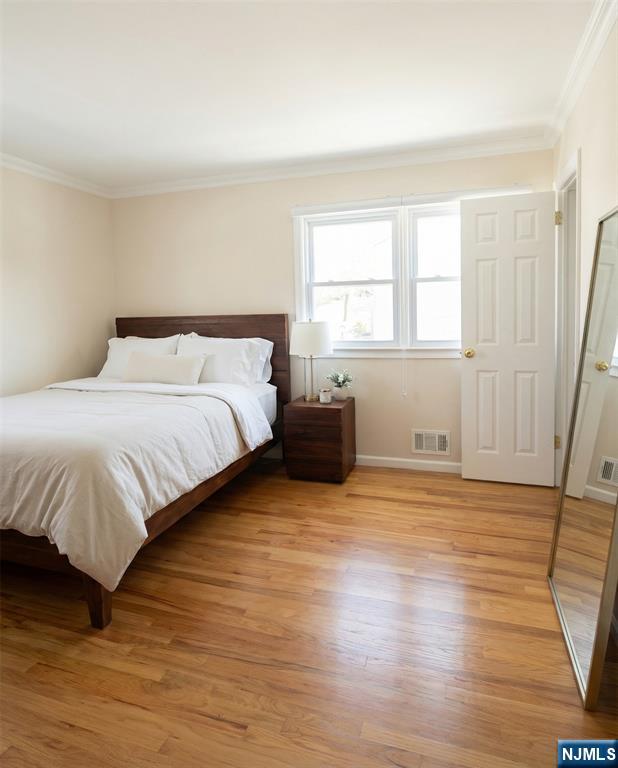 346 Alan Drive Paramus, NJ 07652 - Photo 4 of 21 a bedroom with a bed and wooden floor