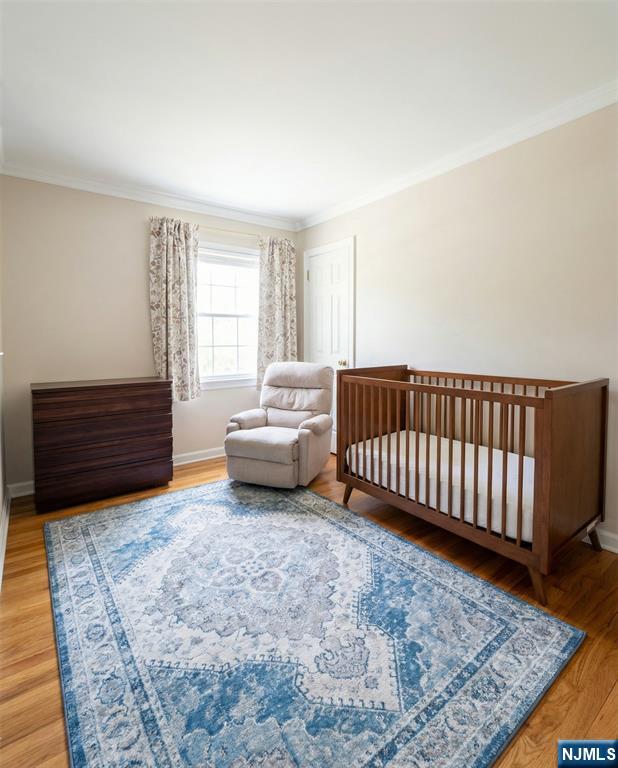 346 Alan Drive Paramus, NJ 07652 - Photo 5 of 21 a spacious bedroom with a bed and a couch