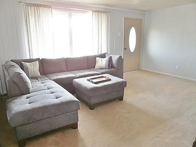 1016 McGovern Road Houston, PA 15342 - Photo 6 of 25 Spacious Freshly painted Light and Bright Living Room with a leaded glass oval window in the updated door to front covered porch! New drapes and sheers stay and there are hardwood floors under the quality wall to wall carpeting.