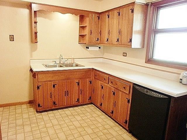 1016 McGovern Road Houston, PA 15342 - Photo 10 of 25 A closer look at the kitchen with solid wood cabinetry with wrought iron handles and hinges, double bowl stainless steel sink, all appliances included.