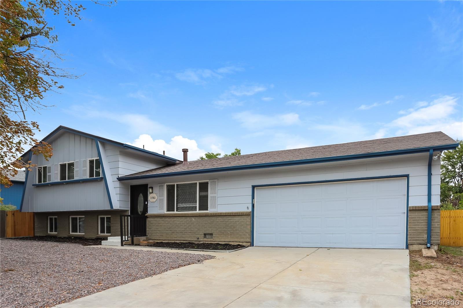 11580 East Ada Place Aurora, CO 80012 - Photo 1 of 18 a front view of a house with a yard and garage