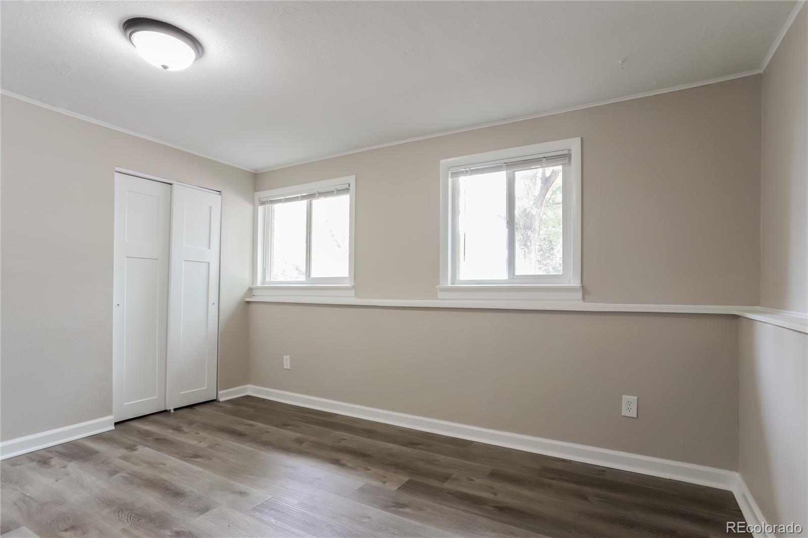 11580 East Ada Place Aurora, CO 80012 - Photo 12 of 18 an empty room with wooden floor and windows