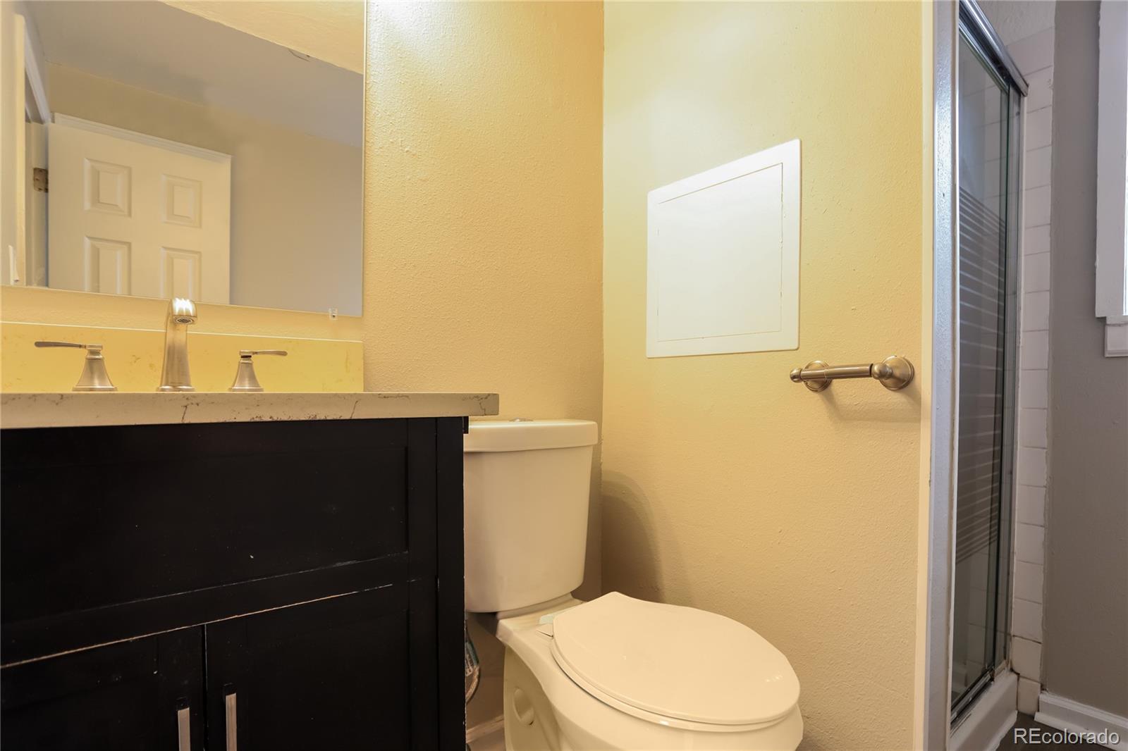 11580 East Ada Place Aurora, CO 80012 - Photo 13 of 18 a bathroom with a sink and a toilet