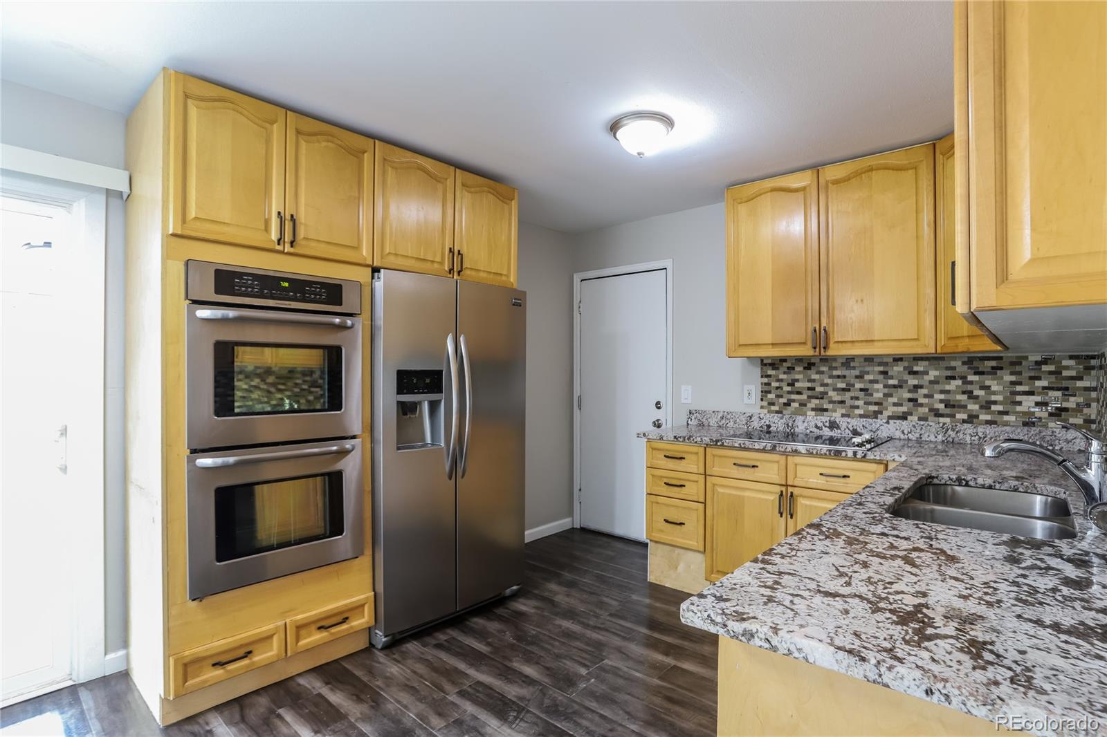 11580 East Ada Place Aurora, CO 80012 - Photo 5 of 18 a kitchen with a sink stove and refrigerator