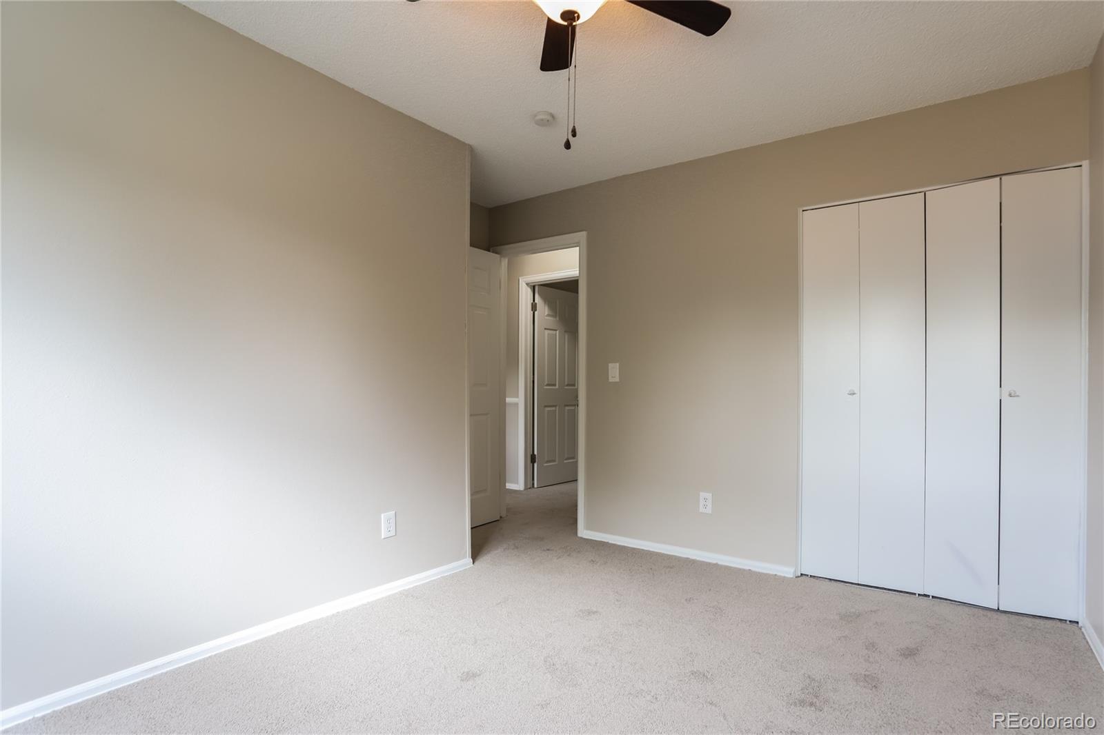 11580 East Ada Place Aurora, CO 80012 - Photo 10 of 18 a view of an empty room with a ceiling fan