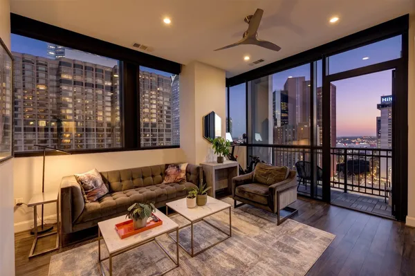 a living room with furniture and a floor to ceiling window