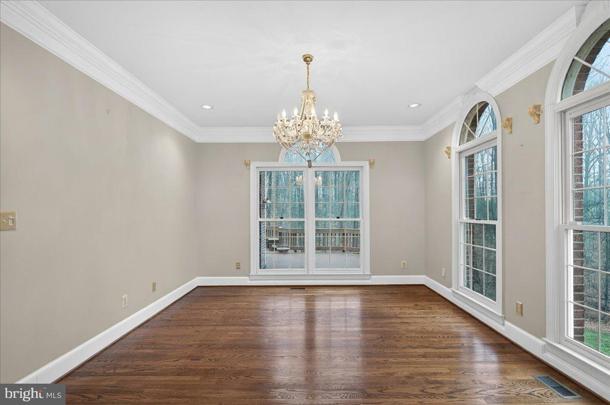6612 Colchester Road Clifton, VA 20124 - Photo 19 of 93 Crown molding and crystal chandelier