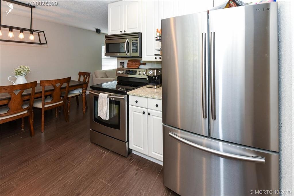 945 Sunset Road West Palm Beach, FL 33401 - Photo 14 of 31 a kitchen with stainless steel appliances a refrigerator stove and microwave