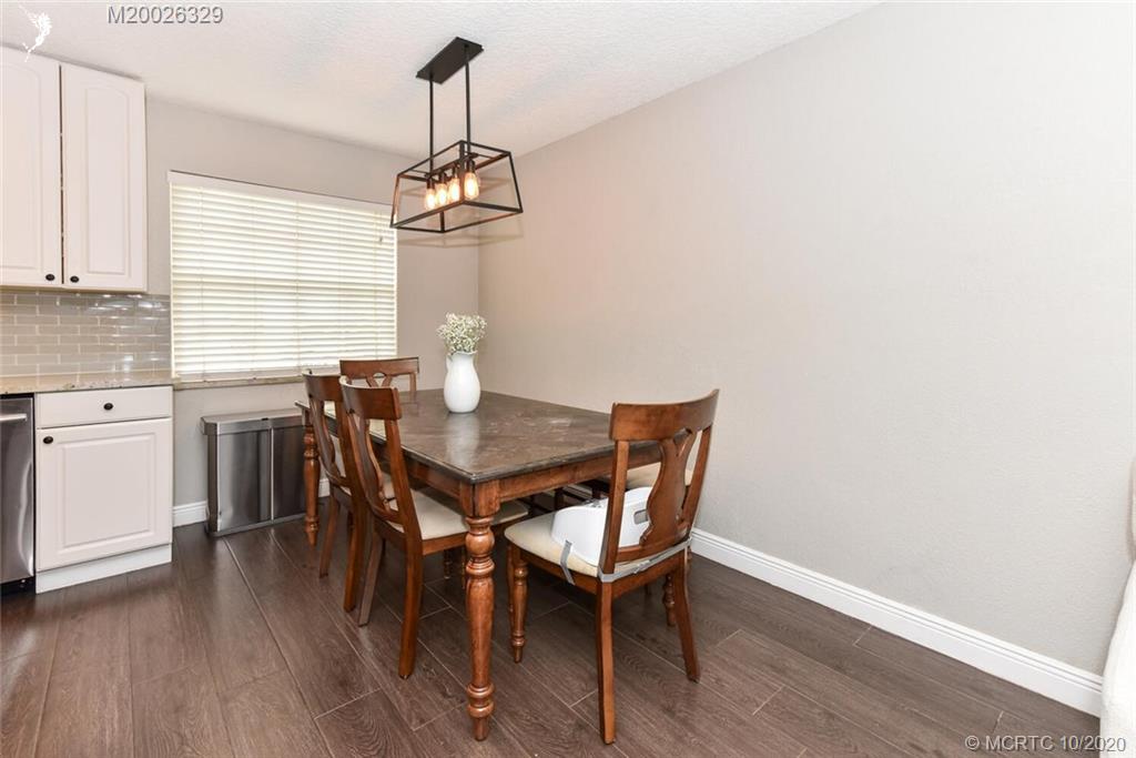 945 Sunset Road West Palm Beach, FL 33401 - Photo 16 of 31 a view of a dining room with furniture window and wooden floor