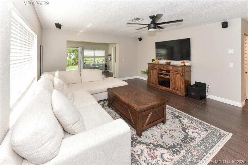 945 Sunset Road West Palm Beach, FL 33401 - Photo 18 of 31 a living room with a flat screen tv and a fireplace