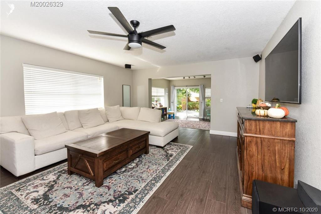 945 Sunset Road West Palm Beach, FL 33401 - Photo 19 of 31 a living room with furniture a ceiling fan and a wooden floor