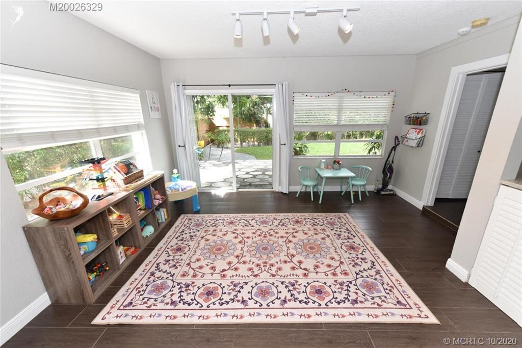 945 Sunset Road West Palm Beach, FL 33401 - Photo 20 of 31 a living room with furniture rug and a table