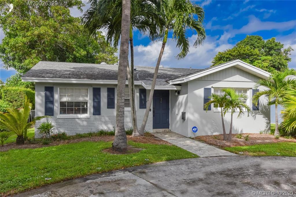945 Sunset Road West Palm Beach, FL 33401 - Photo 2 of 31 a front view of a house with garden