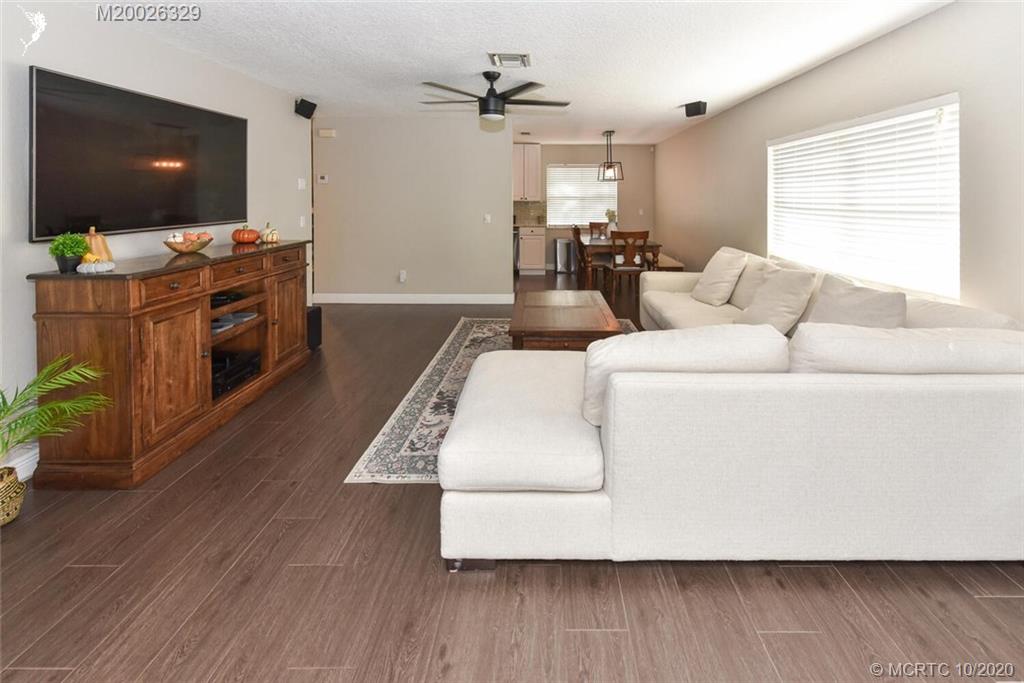 945 Sunset Road West Palm Beach, FL 33401 - Photo 23 of 31 a living room with furniture and a flat screen tv