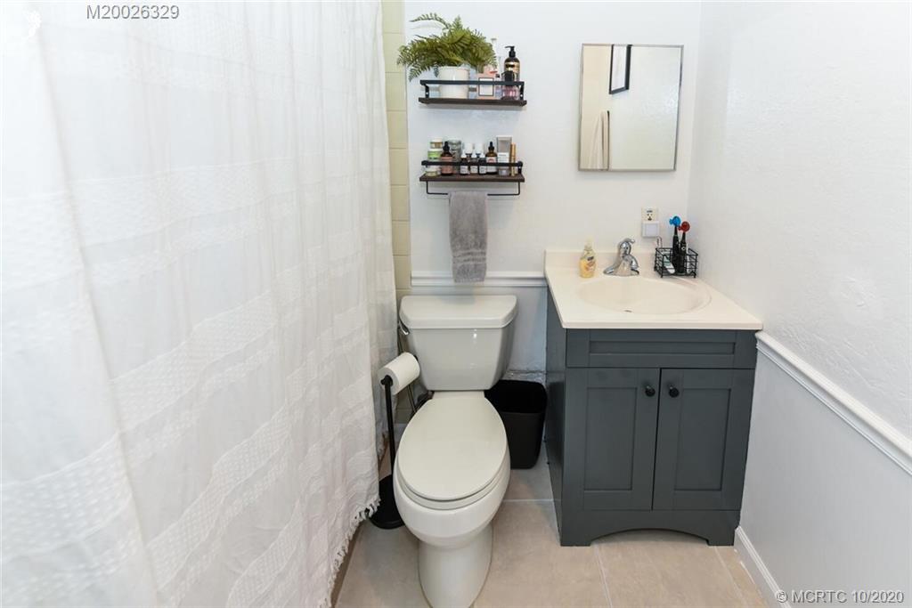 945 Sunset Road West Palm Beach, FL 33401 - Photo 25 of 31 a white toilet sitting next to a bathroom sink