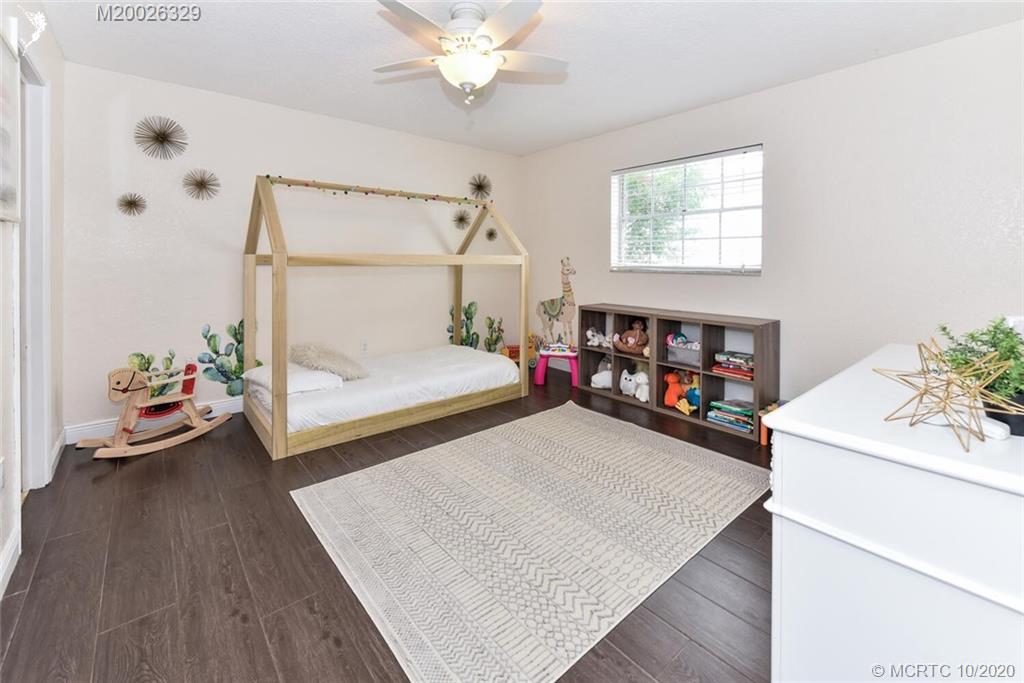 945 Sunset Road West Palm Beach, FL 33401 - Photo 28 of 31 a bed room with a bed and a baby crib