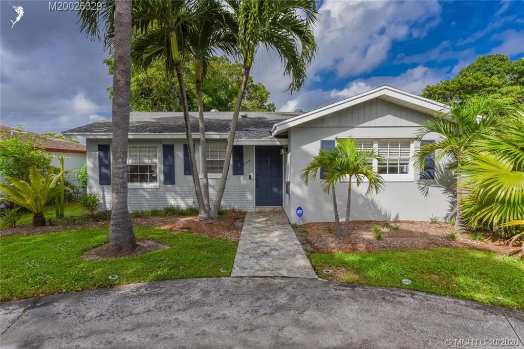 945 Sunset Road West Palm Beach, FL 33401 - Photo 3 of 31 a front view of a house with garden