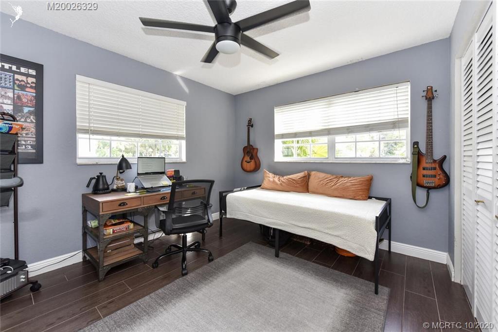 945 Sunset Road West Palm Beach, FL 33401 - Photo 31 of 31 a bedroom with a bed and a chandelier