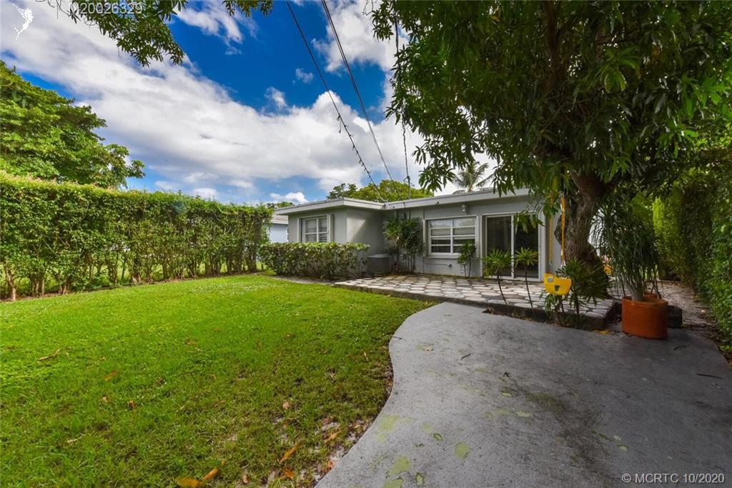 945 Sunset Road West Palm Beach, FL 33401 - Photo 8 of 31 a view of a house with backyard sitting area and garden
