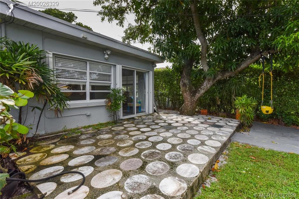 945 Sunset Road West Palm Beach, FL 33401 - Photo 10 of 31 a front view of a house with a yard