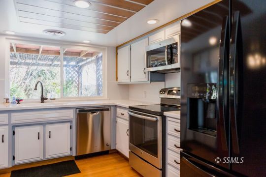 712 Peg Street Ridgecrest, CA 93555 - Photo 9 of 44 a kitchen with cabinets and stainless steel appliances