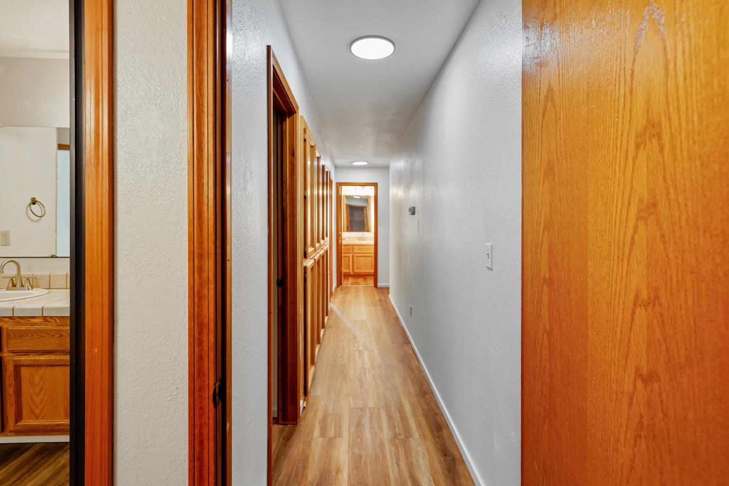 11585 Linnet Court Penn Valley, CA 95946 - Photo 13 of 49 a view of a hallway with wooden floor and staircase