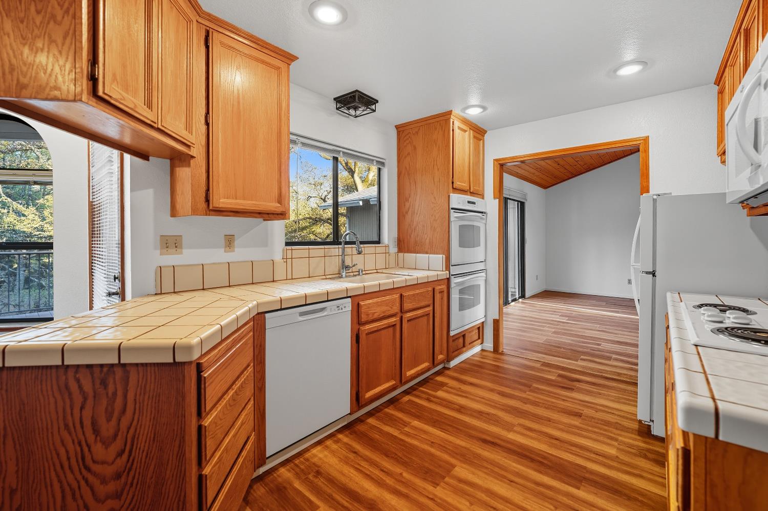 11585 Linnet Court Penn Valley, CA 95946 - Photo 6 of 53 a kitchen with stainless steel appliances granite countertop a sink and wooden cabinets