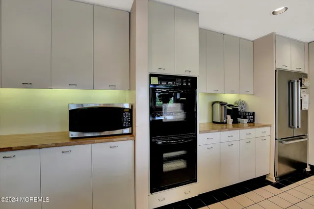 a kitchen with stainless steel appliances a stove a microwave and a refrigerator