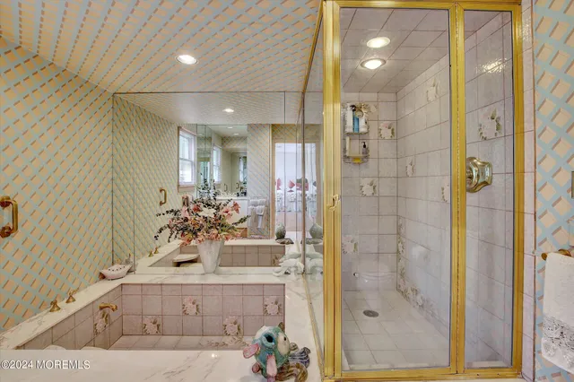 a bathroom with a double vanity sink mirror and shower