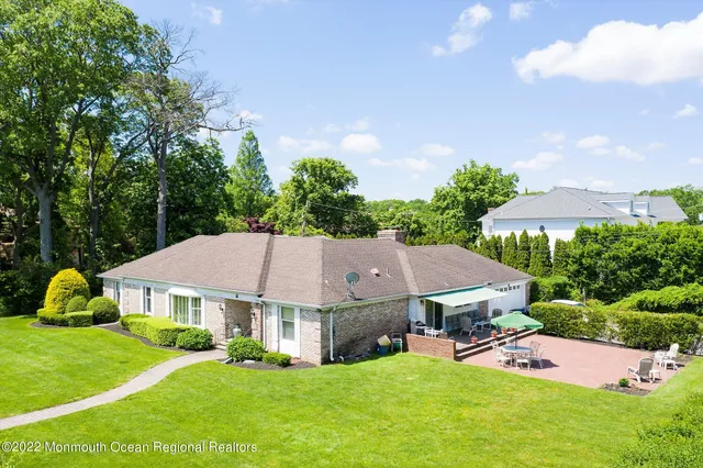 an aerial view of a house with yard porch and furniture
