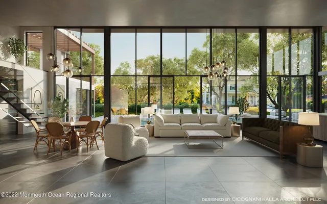 a living room with furniture and floor to ceiling windows