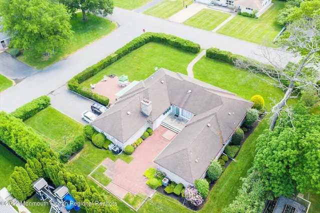 an aerial view of a house with a garden and swimming pool