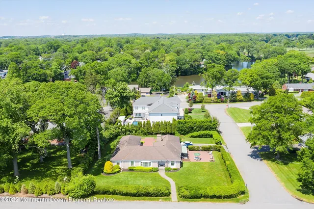 an aerial view of residential houses with outdoor space and street view