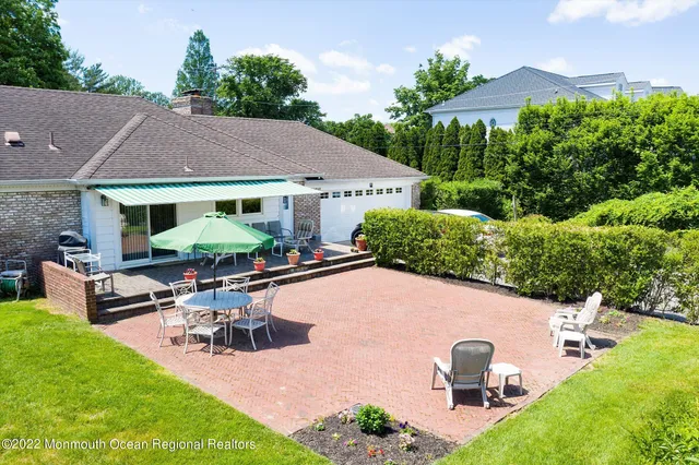 an outdoor space with furniture and garden